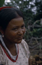 Head and shoulders portrait of Barasana woman  Paulina  Boscos sister  wearing multi-strand white glass bead necklace and silver ear-rings.Tukano sedentary Indian tribe North Western Amazonia America...