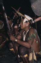 Barasana shaman  Pacico clutches sacred hardwood prayer stave during chanting session. He wears woven monkey fur amulets  woven cumare fibre garters on legs and sweet-smelling herbs on arms plus macaw toucan feather crown Tukano sedentary Indian tribe North Western Amazonia American Colombian Columbia Hispanic Indegent Latin America Latino Religion South America Tukano One individual Solo Lone