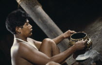 Barasana tribesman  Pacico  a shaman painting clay design onto yaje pot used to hold hallucinogenic yaje juice from vine species Banisteriopsis used for shamanic and religious purposesTukano sedentar...