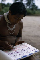 Young Barasana shaman Pacico draws for anthropologist Stephen Hugh-Jones the colour visions he sees when under the influence of hallucinogenic drug Yage.Tukano sedentary Indian tribe North Western Am...