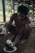 Maku hunter Umero taking salt - a valued commodity  from bottle.indigenous tribe indian nomadic American Colombian Columbia Hispanic Indegent Latin America Latino Male Men Guy South America Vaupes Ma...