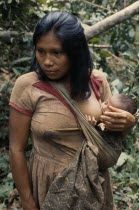 Young Maku mother breast-feeding baby carried in sling across her body.indigenous tribe indian nomadic American Babies Colombian Columbia Hispanic Indegent Kids Latin America Latino Mum South America...