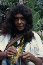 Portrait of Ika woman  one of the powerful Villafana family living in the Guatapuri river valley on the South side of the Sierra. Wearing multiple necklaces of brightly coloured glass beads  a sign of...