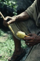 Cropped detail of Ika man holding a poporo small gourd containing finely powdered lime.Ika men can spend hours rubbing their gourds with their palitos small sticks  in ceremonies in conversation or in...