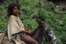 Ika boy in traditional woven wool&cotton manta cloak rides his donkey into the Sierra.Arhuaco Aruaco indigenous tribe American Colombian Colombia Hispanic Indegent Kids Latin America Latino South Ame...
