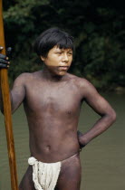 Rio Verde  a young Embera  with lower face and body painted with black dye extracted from the inedible Jagua fruit holding a palanca/pole - used for guiding canoe through rapids on rio Condoto.Pacifi...