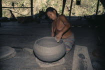 Old Embera woman coiling a large clay cooking pot. Skill is only continued by a very few elderly women since ceramic pots have been replaced by aluminium.Pacific coastal region tribe vessel American...