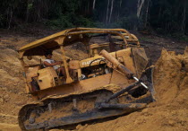 Bulldozer opening road through deforested area now a garimpo gold mine in former Panara territory.Garimpeiro settlers have displaced the Panara Indians formally known as Kreen-Akrore  Krenhakarore  Kr...