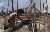 Garimpeiro washing mine tailings for gold on former Panara territory.Small scale garimpeiro prospectors mners in informal sector have                      displaced Panara Indians formerly known as K...