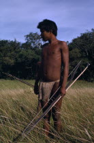 Cuiva Indian hunter  one of a hitherto uncontacted group  in Llanos grasslands bordering rivers Agua Clara & Casanare  with macana wood bow  bamboo arrows and beaten bark-cloth guayuko loincloth.By 20...