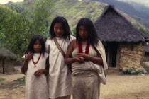 Kogi-Wiwa children in traditional woven wool&cotton mantas cloaks  girls with red glass beads and boy with mochila shoulder bag  Avingue village on southern side of Sierra.  Tribal Indigenous Classic...