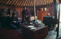 Interior of yurt with family having meal in Summer.