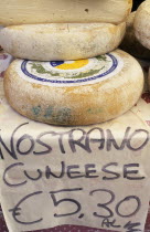 Display of nostrano cheeses for sale with price in euros.