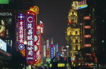 Nanjing Lu.  Street scene at night with mass of illuminated neon signs and advertising.