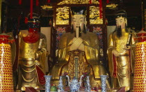 Yu Gardens  Temple of the City of God.  Three golden statues behind small altar.