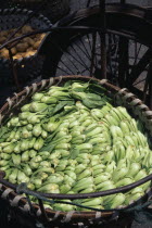 Pak Choi packed in large  circular woven wicker basket.