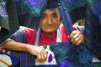 Lady with colourful table mats  near San Cristobal de las Casas