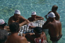 Szecheny Baths. A group of men playing a game of Chess in the thermal water
