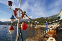 Waterfront restaurants with fishing nets and nautical decoration looking out towards the sea