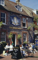 The Druids Head Pub exterior with people sat outside at tables