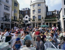 The North Lanes. East Street. People eating and drinking at tables outside busy restaurants and pubs