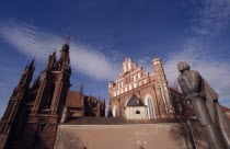 Saint Francis and Bernardine Church behind the Adam Mickiewicz statue