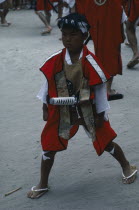 Young boy wearing traditional costume and carrying short sword at village festival.  In feudal times Kyushu was notable for the power of its great daimyo families and the festival celebrates the samur...