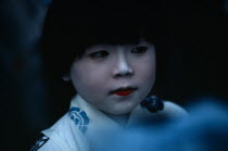 Gion Festival.  Portrait of young girl with white painted face signifying purity and gentleness of birth.