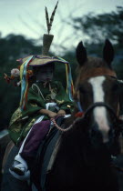 Gion Festival.  A young boy dressed as a courtier of the Heian period prepares to ride through the streets of Kyoto.