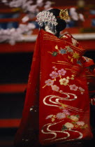 Bunraku puppet female character. Heroines are not permitted the same open displays of emotion as the male characters and hide their feelings with a towel or fold of their kimono.