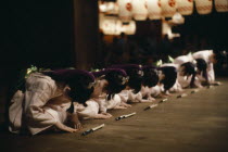 During the Gion festival line of young girls finish their dance with a deep bow of respect to their audience and to the gods of the shrine.