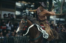 Yabusame mounted archery at Hachimangu shrine festival.  Horseback archery has been a feature of the shrine s festival since the early days of the Kamakura period  1192-1333  and this rider wears a sa...