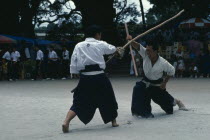 Villagers fighting with sticks replacing swords during the samurai festival of Kaseda shrine.  Masks and protective clothing are not worn.