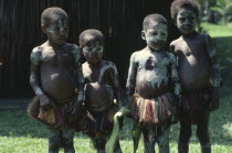 Sepik children wearing body paint and grass skirts.