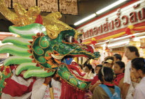 Chinese New Year celebrations. Chinese dragon dancers inside Warorot Market  Chiang Mais China Town