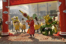 Chinese New Year celebrations. Dwarf  lion dancers  dragon dancers and exploding firecrackers at the conclusion of the parade  Warorot Market area Chiang Mais China Town
