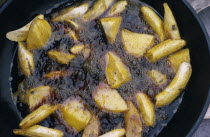 Cassava and plantain frying in oil.