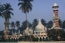 Masjid Jamek or Friday Mosque.  Exterior with domed roof and red and white striped minarets.