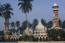 Masjid Jamek or Friday Mosque.  Exterior with domed roof and red and white striped minarets.