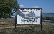 Billboard with AIDS prevention poster produced by the National Aids Prevention and Control Programme.