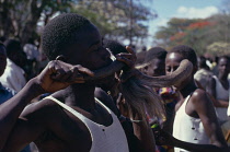 Ngomas dancers using an animal horn as a musical instrument