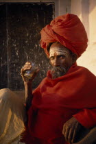 Sadhu Holy man holding morning Chai