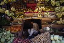 Vendor amongst fruit stall