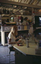 AUSTRALIA Byron Bay. Internet cafe with girl at computer terminal.