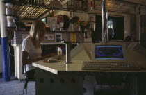 AUSTRALIA Byron Bay. Internet cafe with girl at computer terminal.