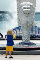 A YOUNG BOY LOOKS ON AT A MINI VERSION OF THE MERLION STATUE. The Merlion is one of the most well-known tourist icons of Singapore. Its landmark statue  once at the Merlion Park  was relocated to the...