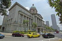 Old colonial building with new high rise buildings in the background.