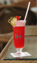 A SINGAPORE SLING COCKTAIL AT THE LONG BAR OF THE RAFFLES HOTEL WHERE THE COCKTAIL WAS INVENTED.The Singapore Sling is a cocktail that was invented by Ngiam Tong Boon for the Raffles Hotel in Singapor...