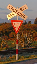 HOKITIKA  RAILWAY LEVEL CROSSING ROAD SIGN ON THE WESTERN COASTAL ROAD ROUTE 6 OUTSIDE HOKITIKA ON THE SOUTH ISLAND. THE SIGN WARNS OF FRIEGHT TRAINS RUNNING FROM GREYMOUTH TO HOKITIKA.Antipodean Oce...