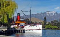 QUEENSTOWN  VINTAGE STEAMSHIP TSS EARNSALW DOCKED AT STEAMER WHARF QUEENSTOWN WHICH TAKES TOURISTS FOR CRUISES ON LAKE WAKATIPU WITH THE REMARKABLES MOUNTAINS BEHIND.Antipodean Oceania